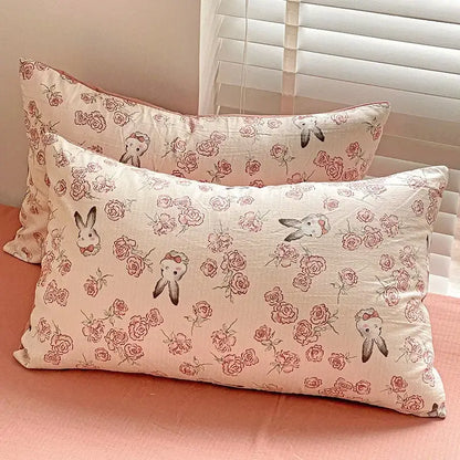 Cream-colored pillowcases with delicate pink roses and bunny illustrations in floral pink and cream cotton flower printed comforter set
