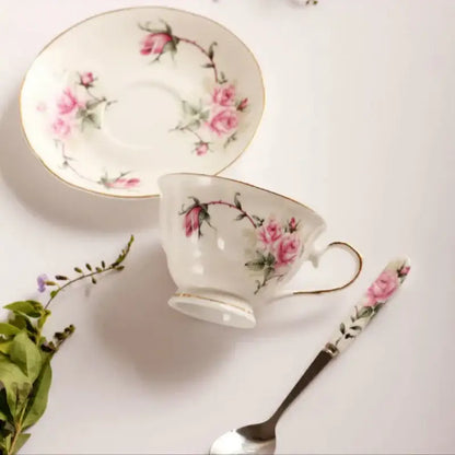 Delicate white porcelain tea cup set with hand-painted pink roses and green vines for dining room coffeeware