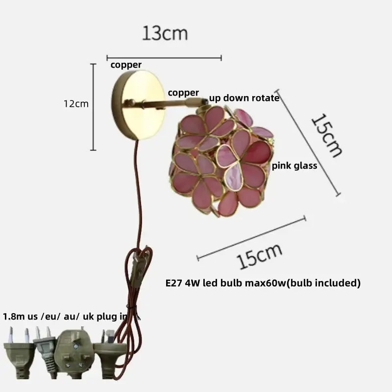 A wall light with copper-finished adjustable arm and pink decorbites butterfly glass floral design for bedroom