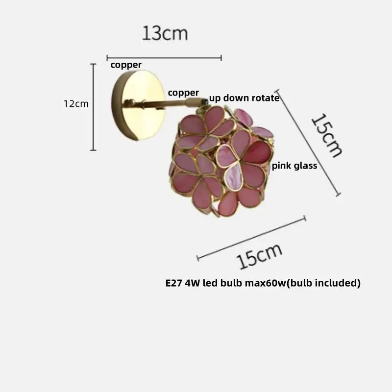 A floral pink and teal decorbites butterfly glass wall light with copper base and adjustable arm for bedroom use