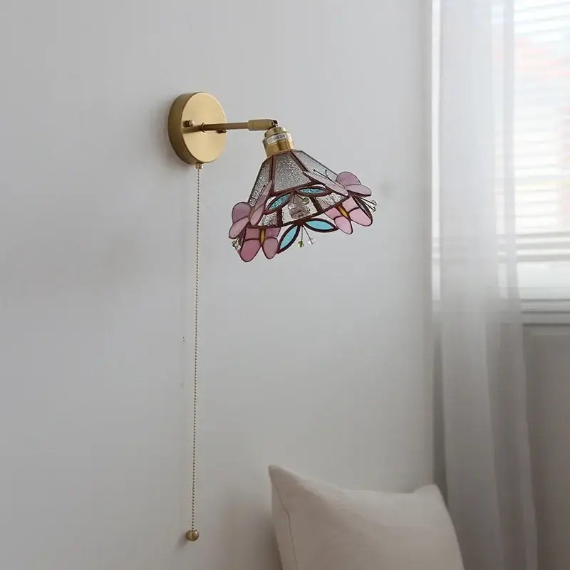 A delicate tiffany-style decorbites butterfly glass wall light with pink teal floral stained glass shade and gold frame