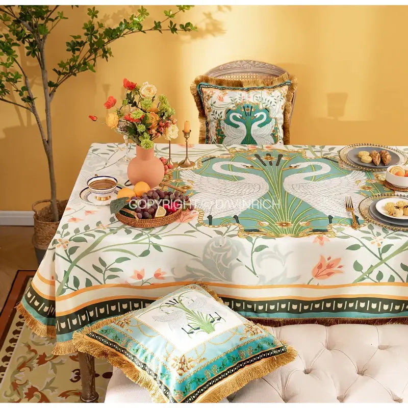 Elegant white floral print velvet tablecloth with green and gold swan design and teal mustard yellow border for dining room decor