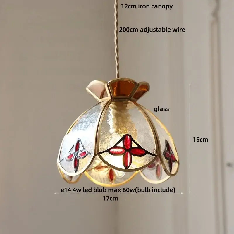 A delicate 15cm-tall pendant lamp with brass-toned iron canopy and red floral frosted glass panels for dining decorbites crown diamond glass