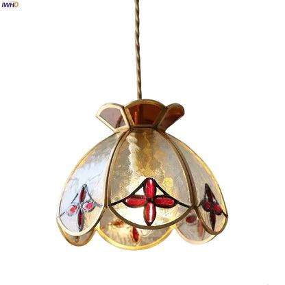 A gold-toned pendant lamp with translucent floral red and amber crown diamond glass shade for dining room decorbites crown diamond