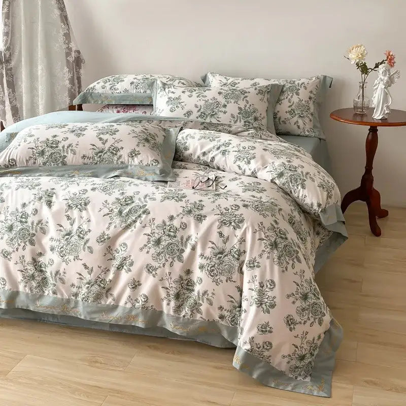 A cream cotton wide edge duvet cover with green floral pattern and teal satin border from decorbites bedding sets
