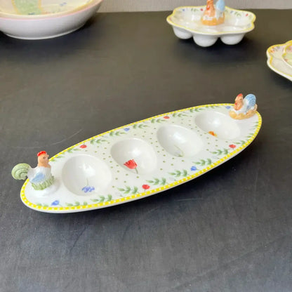 Floral scalloped white porcelain tulip dinnerware set featuring a white ceramic egg tray with yellow trim and rooster accents