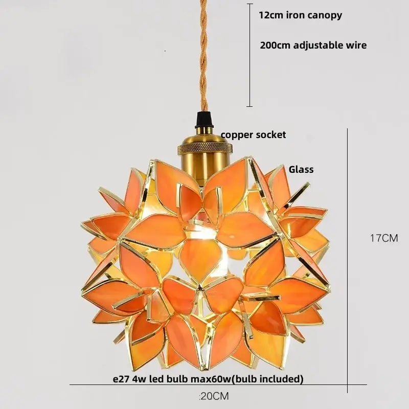 Orange glass leaf pendant light fixture with gold-toned metal accents and copper socket for dining room use