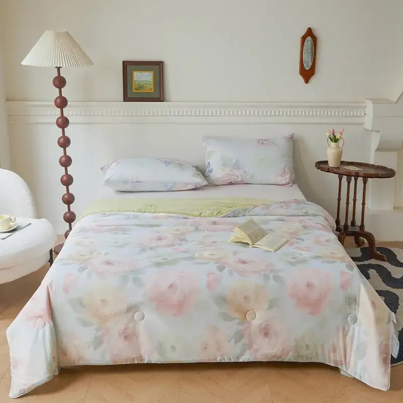 Pastel floral comforter with soft pink and peach blossoms on light blue background featuring subtle button detailing decorbites knitted cotton summer quilt