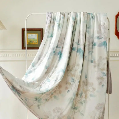 A flowing white scarf with delicate floral patterns in soft blue and beige draped over a metal rack for decorbites knitted cotton print