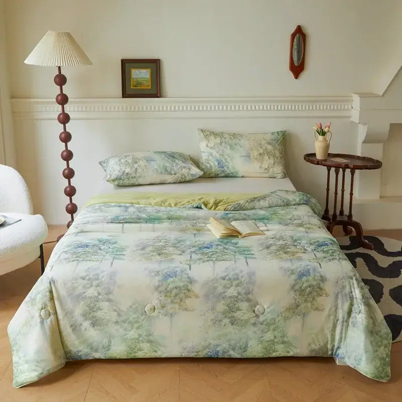 Floral teal and lavender decorbites knitted cotton print summer quilt with a soft watercolor forest design in muted greens and blues