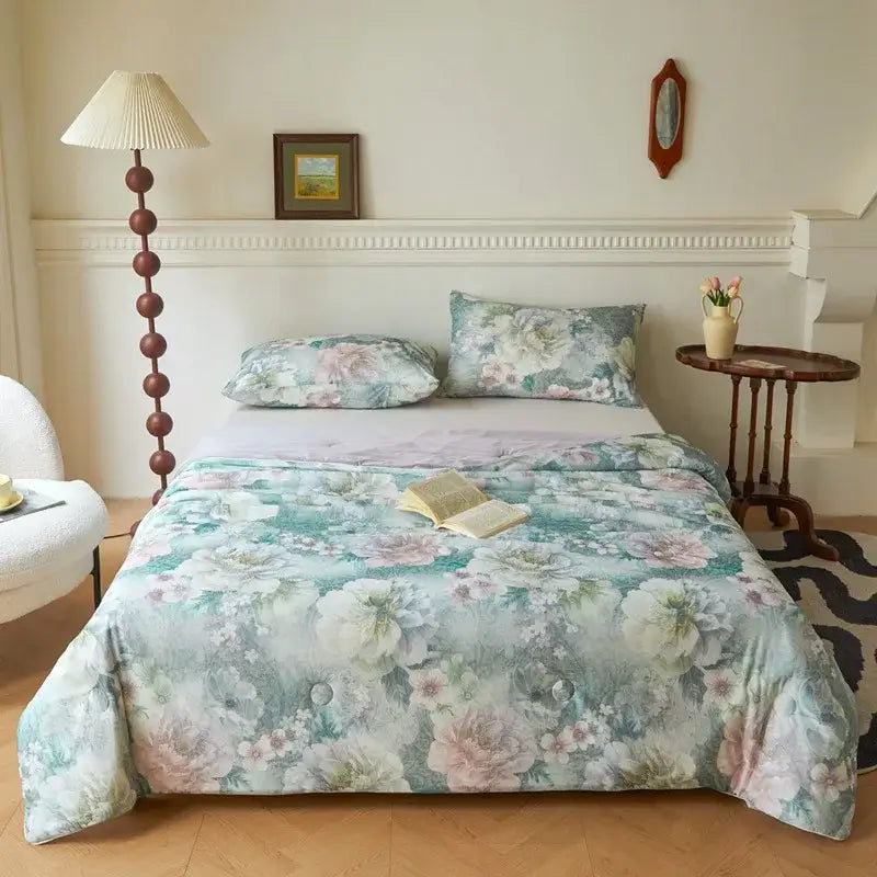 A soft summer quilt in muted teal and blush pink with floral knitted cotton print by decorbites