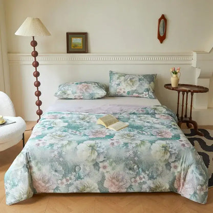 A soft summer quilt in muted teal and blush pink with floral knitted cotton print by decorbites
