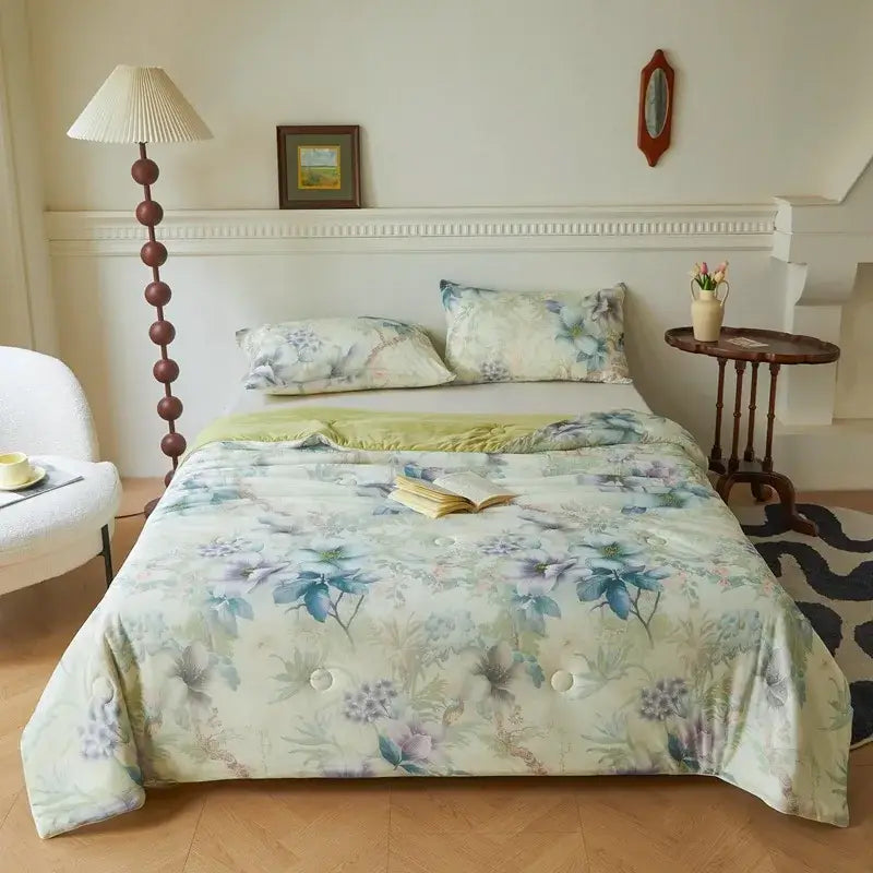 A soft floral teal and lavender summer quilt with a subtle green border in decorbites knitted cotton print material