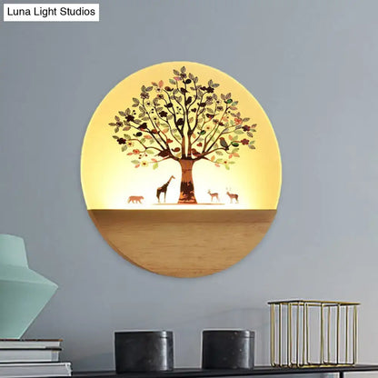 Circular wall light with warm yellow glow featuring animal flowering tree design on acrylic shade and wooden base