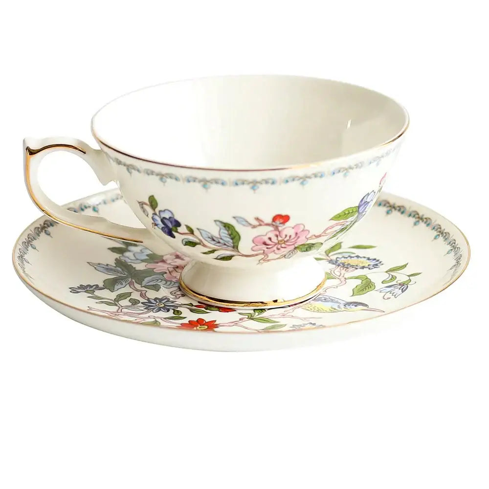 Delicate white bone china tea cup set with vibrant floral pattern and gold rim for elegant dining room use