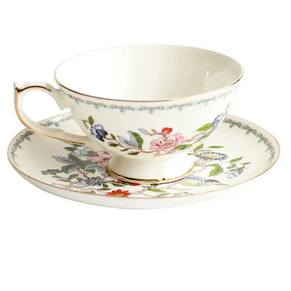 Delicate white bone china tea cup set with vibrant floral pattern and gold rim for elegant dining room use