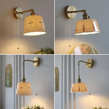 Antique brass led wall light with cream ceramic shade featuring delicate embroidered patterns and a built-in switch