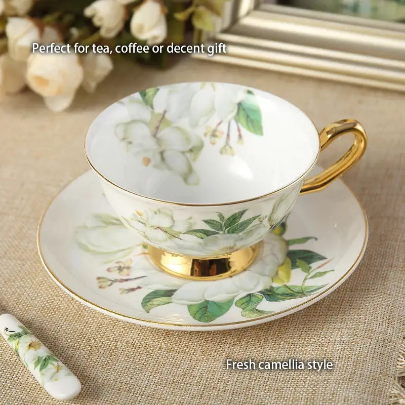 White porcelain teacup with gold trim and camellia bone floral design paired with matching decorbites camellia saucer