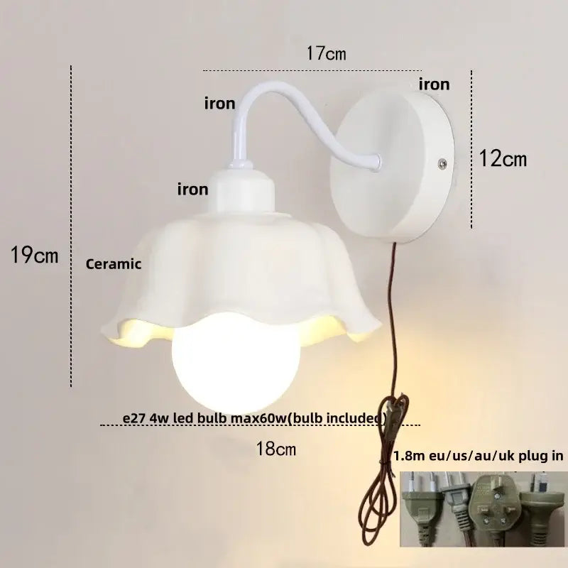 Floral white glass iron led wall sconce with curved iron arm and circular wall mount for bedroom decorbites glass iron