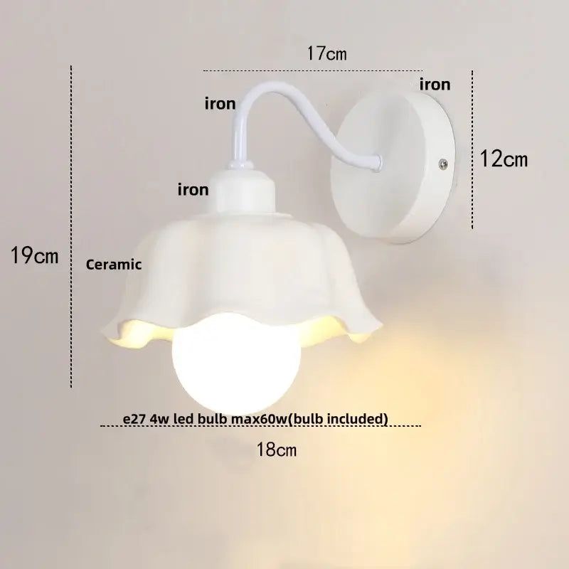 Floral white glass wall sconce with a white ceramic fluted shade and iron bracket featuring a pull chain switch wall sconce