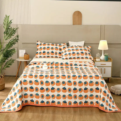 Orange pumpkin patterned quilt with blue accents on white background in floral white and green cotton double bedspread decorbites set
