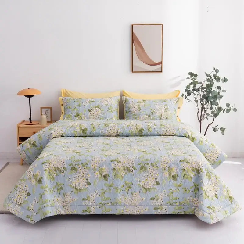 Light blue quilted cotton bed cover set with white and green floral pattern suitable for bedroom use