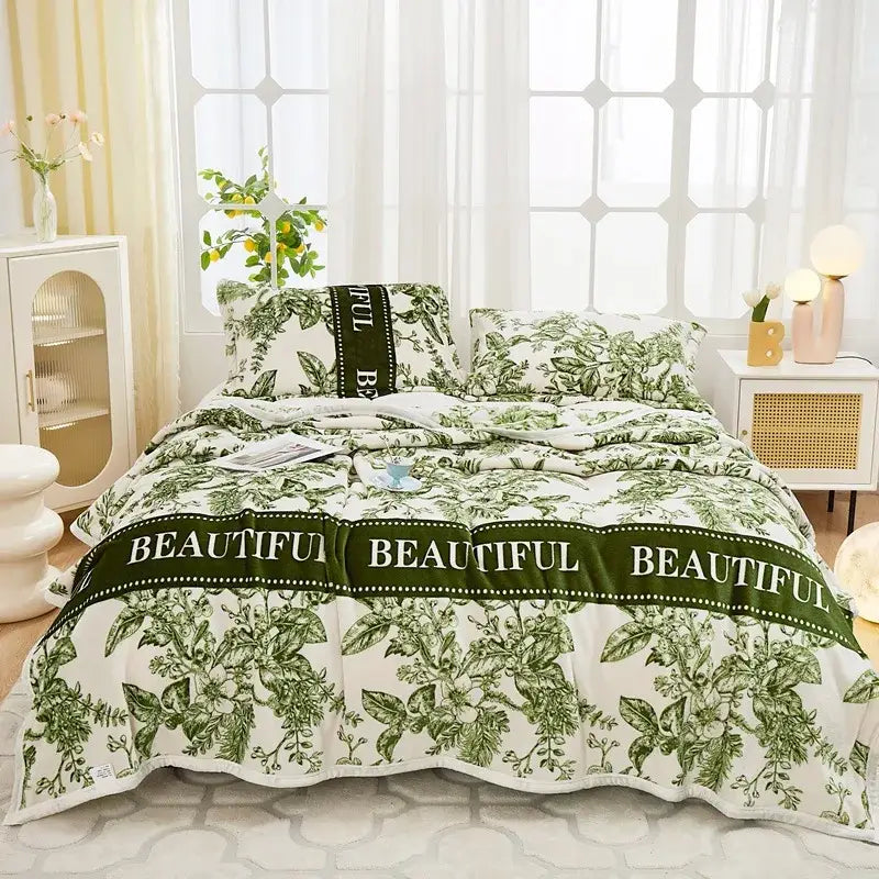 Floral white and navy cozy flannel plush blanket featuring green and white botanical print bed set with beautiful banner