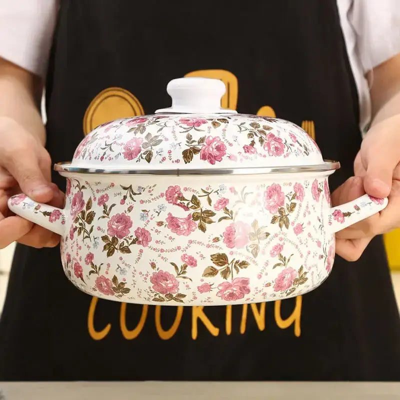A white enamel ceramics soup saucepan with pink and brown floral patterns and matching lid in silver rim
