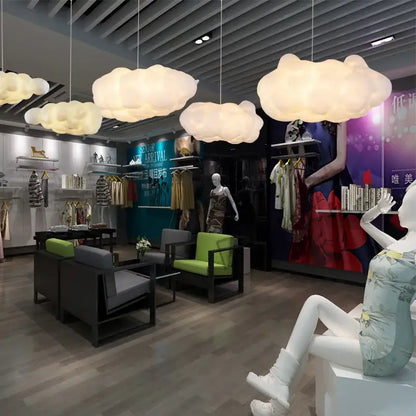 Fluffy white cloud ceiling chandelier with opaque white material pendant lights emitting soft warm glow