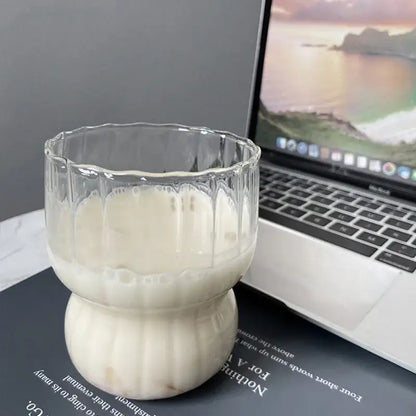 Clear fluted glass coffee mug with a bulbous base filled with creamy liquid from decorbites glass collection