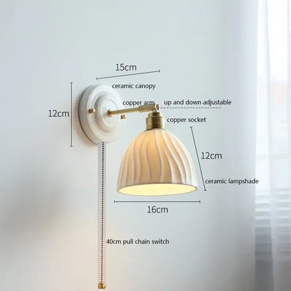 Cream-colored ceramic wall lamp with fluted shade and brass-finished copper arm for bathroom decorbites ceramic wall lighting