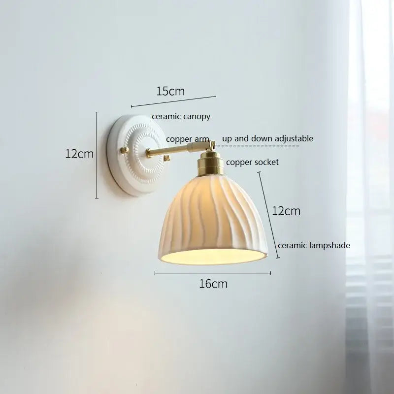 Fluted cream ceramic wall lamp with ribbed lampshade and brass accents ideal for bathroom decorbites ceramic wall lamp