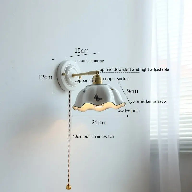 Fluted cream ceramic wall lamp with brass accents featuring a butterfly-decorated fluted ceramic wall lamp shade