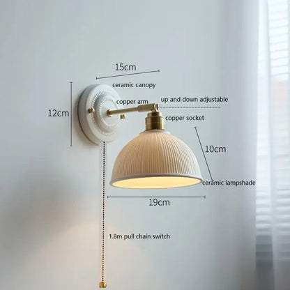 Fluted cream ceramic wall lamp with vertical ridges mounted on brass copper arm for decorbites ceramic wall lighting