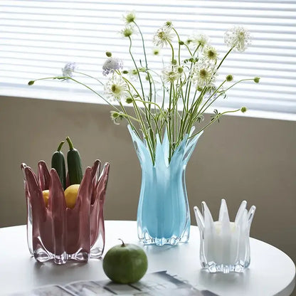 A translucent light blue geometric bud glass vase with fluted crown design holding white and green flowers decorbites decor