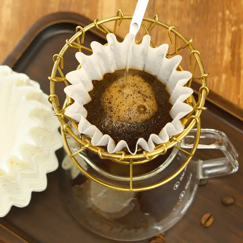 Gold wire coffee dripper with disposable white paper fluted decorbites coffee filters brewing dark coffee