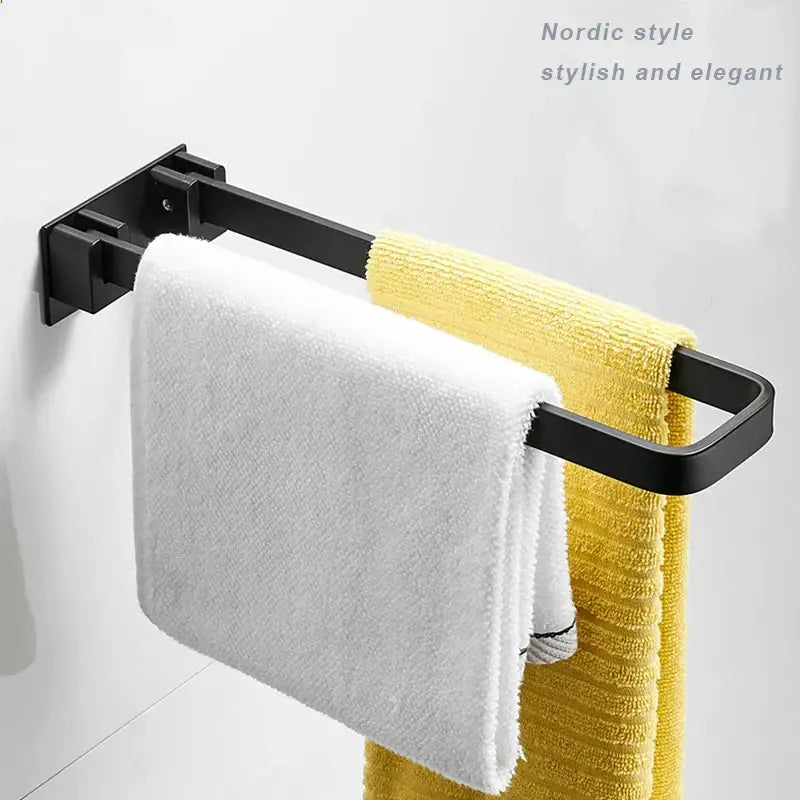 Foldable black and silver aluminum single layer towel rack by decorbites holding white and yellow textured towel