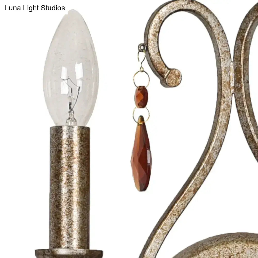 Antique brass-finished wrought iron wall lamp with aged silver crystal deco and amber beads for dining room use