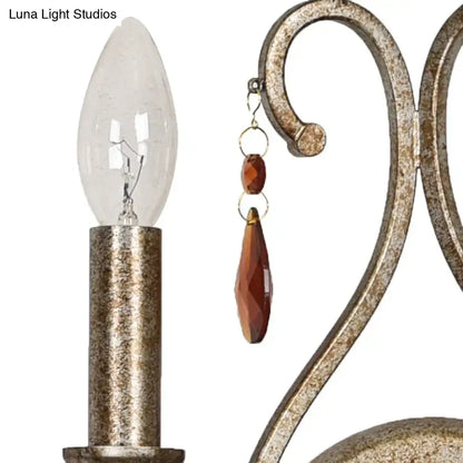 Antique brass-finished wrought iron wall lamp with aged silver crystal deco and amber beads for dining room use
