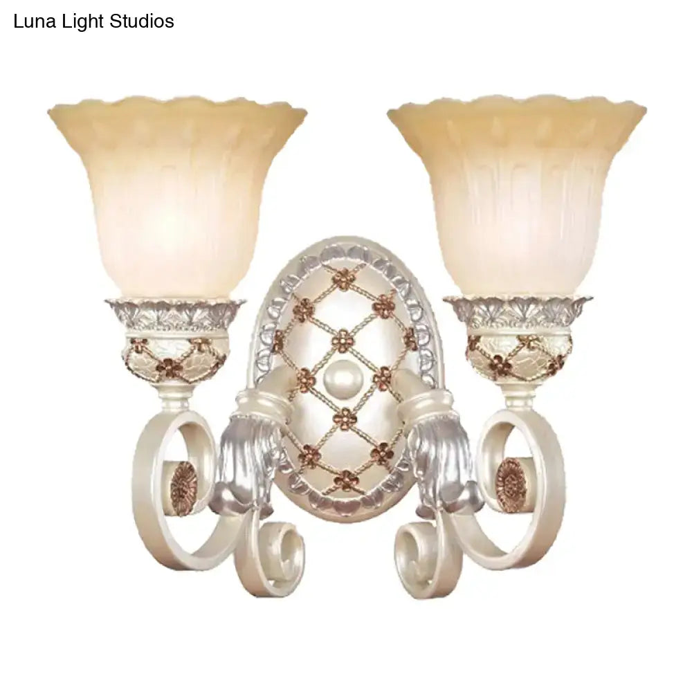 Antique white and gold wall sconce with two fluted opaline glass shades for elegant living room lighting