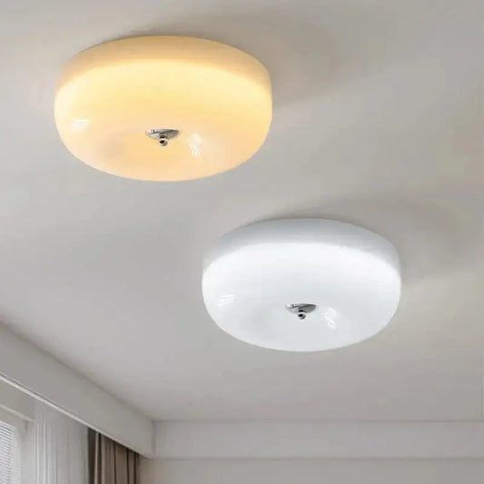 Two decorbites french cream ceiling lamps with warm yellow and white frosted glass shades for bedroom lighting decor
