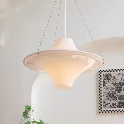 A cream modern chandelier featuring a white ceramic pendant with a sleek flared design and thin metal chains for dining rooms decorbites french cream