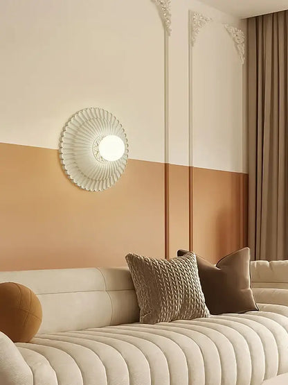 A french cream wall lamp with a white circular fluted petal design and frosted glass bulb for elegant decorbites french cream style