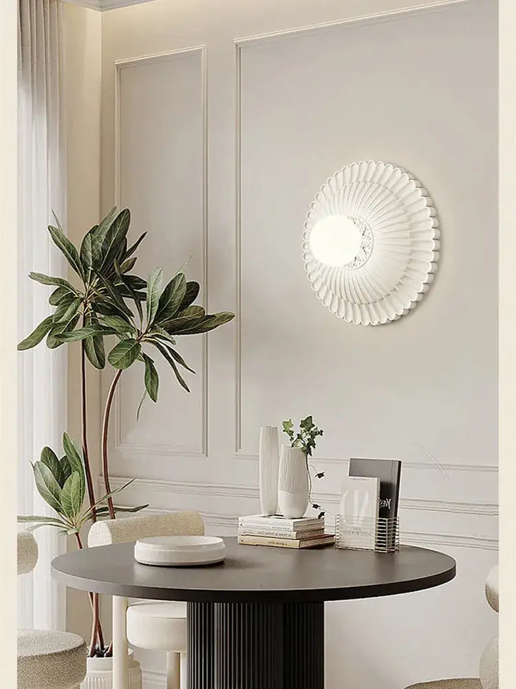 White fluted decorbites french cream wall lamp with circular petal design and central illuminated panel for bedroom use
