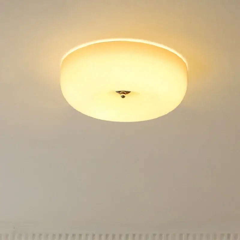 Warm-toned french cream ceiling lamp with translucent glass shade and metallic fixture for bedroom decorbites french cream