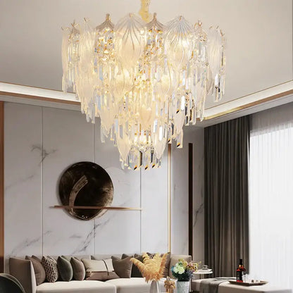 A french crystal chandelier pendant light with tiered clear and frosted glass leaves on gold-toned arms