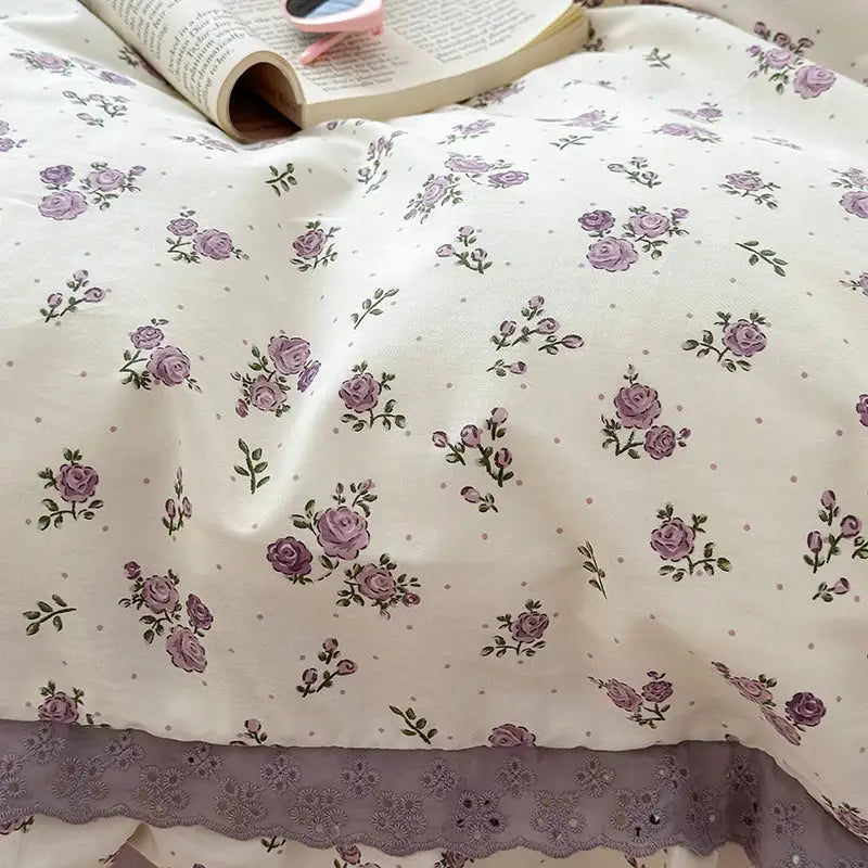 Cream-colored bedding set with purple rose patterns and double layer lace ruffles featuring matching lace trim