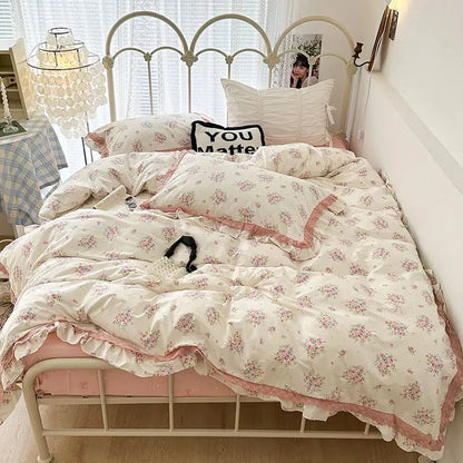 Floral-patterned bedding set with double layer lace ruffles in cream and purple featuring delicate pink hues and soft pastel tones