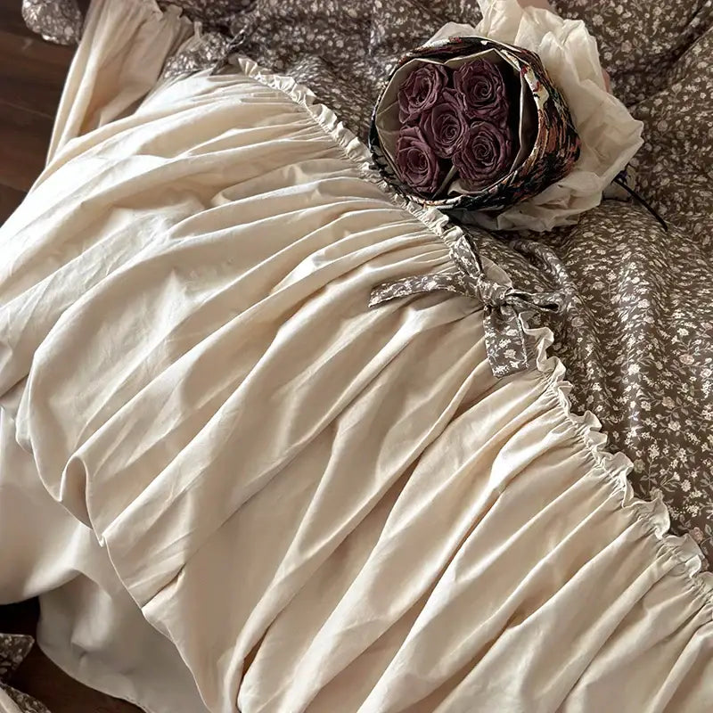 A cream-colored ruffled cotton dress with lace trim and gathered waistband featured in decorbites french floral bedding set
