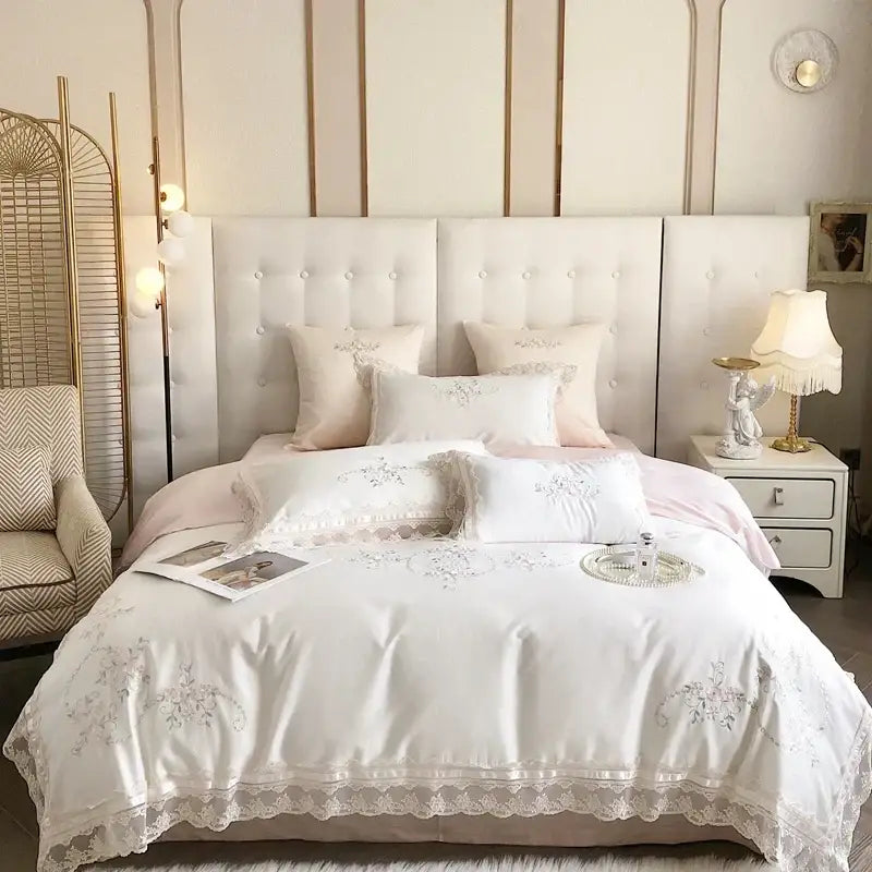 White lace-edged embroidered bedding set with delicate floral patterns and soft pink accents french lace flowers